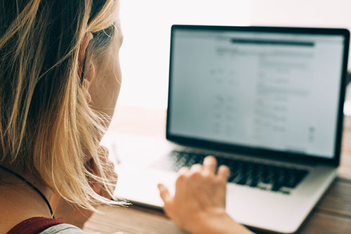 Woman seeing ransomware on laptop